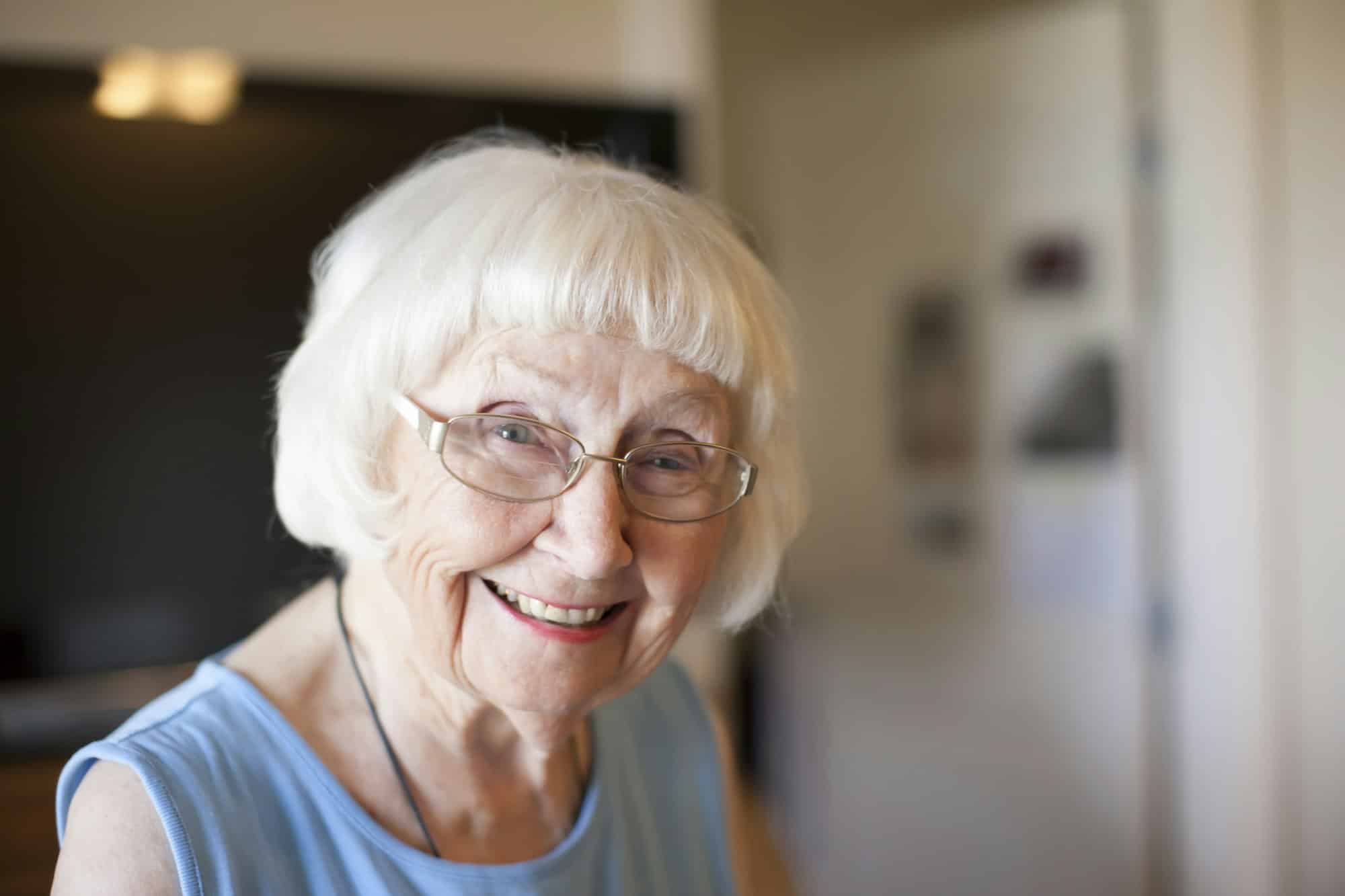 https://movingsquad.com/wp-content/uploads/sites/8/2024/03/portrait-of-senior-woman-indoors-smiling.jpg